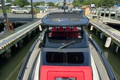 Slide: The Image of 2021 BRABUS 900 Shadow luxury boat docked, featuring sleek design and red seating. - 27