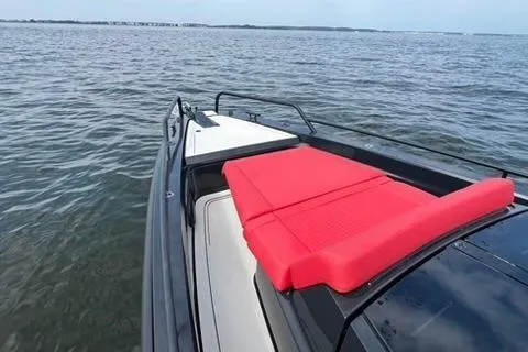 Slide: The Image of 2021 BRABUS 900 Shadow yacht with red seating, cruising on open water. - 14