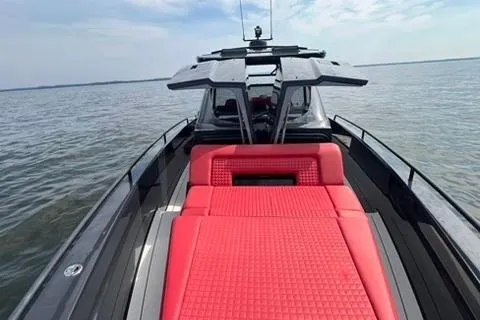 Slide: The Image of 2021 BRABUS 900 Shadow yacht with sleek design and vibrant red seating on open water. - 16
