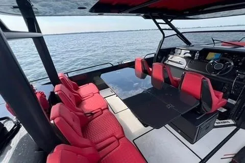 Slide: The Image of 2021 BRABUS 900 Shadow boat interior with red seating and sleek design on open water. - 21