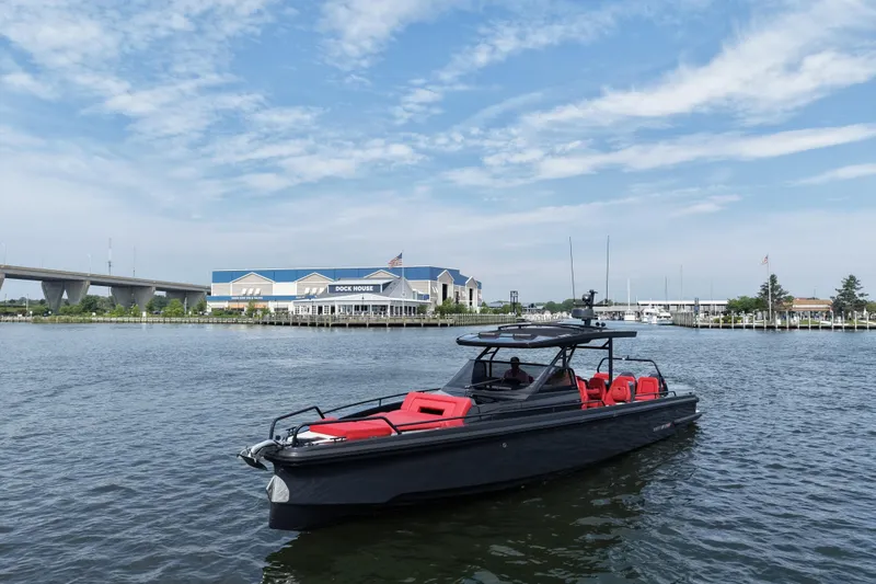 Slide: The Image of 2021 BRABUS 900 Shadow yacht on water near dock house, under blue sky. - 11