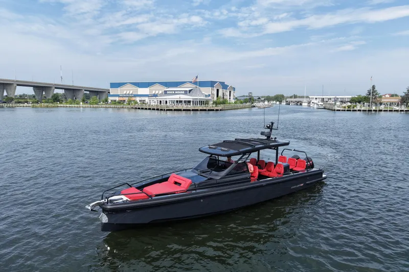 Slide: The Image of Luxury 2021 BRABUS 900 Shadow yacht with red seating, cruising near a marina. - 10