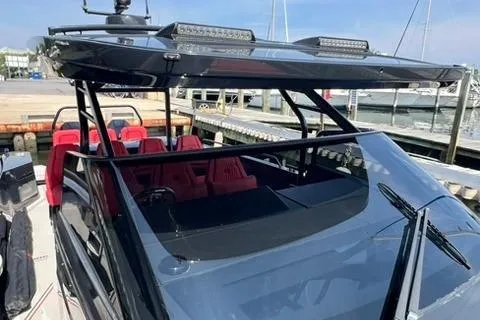 Slide: The Image of 2021 BRABUS 900 Shadow boat with sleek design and red seating at a marina. - 29