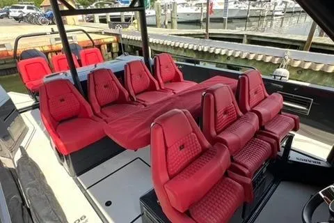 Slide: The Image of 2021 BRABUS 900 Shadow boat with luxurious red seating, docked at a marina. - 30