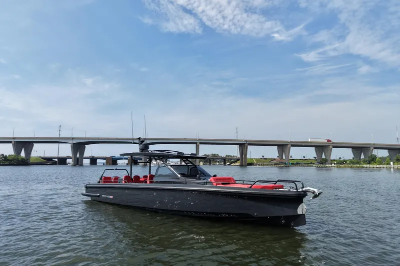 Slide: The Image of 2021 BRABUS 900 Shadow boat on water with bridge in background, under blue sky. - 6