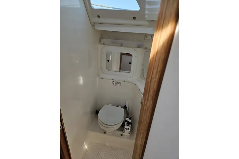 Slide: The Image of 1998 Catalina 320 boat bathroom interior with toilet and window. - 64