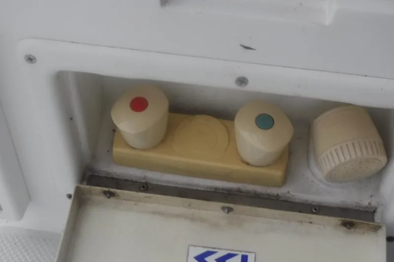 Slide: The Image of Control panel with red and blue knobs on a 1998 Catalina 320 boat. - 15