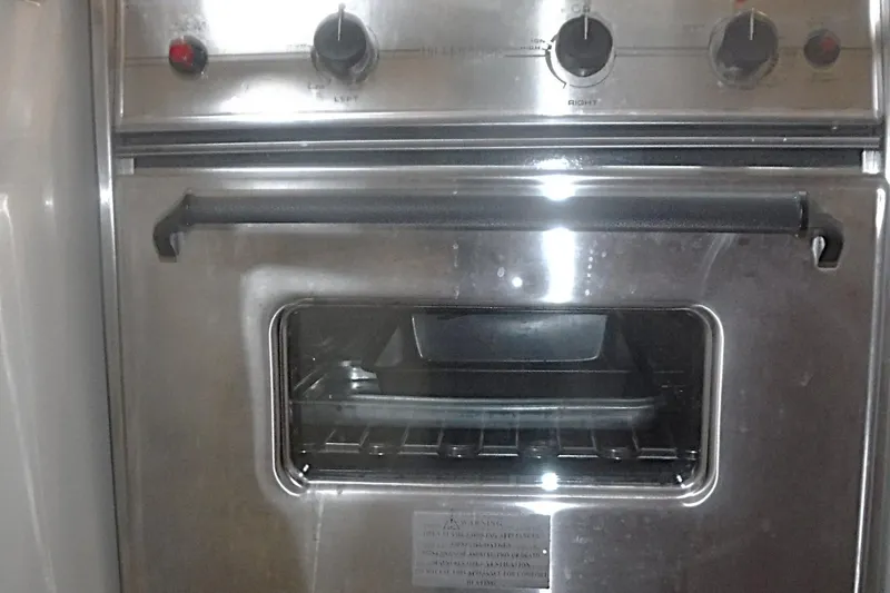 Slide: The Image of Stainless steel oven with control knobs, Catalina 320 model, 1998. - 34