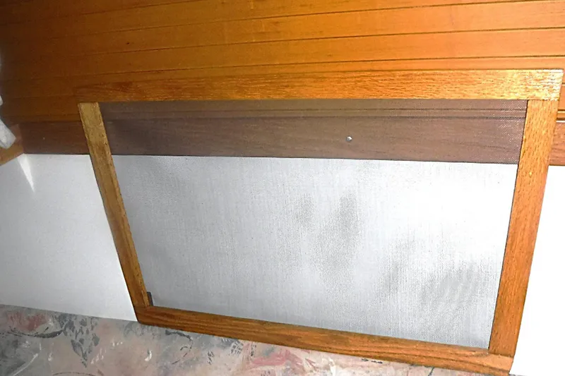 Slide: The Image of Wooden-framed screen on a 1998 Catalina 320 boat interior. - 56