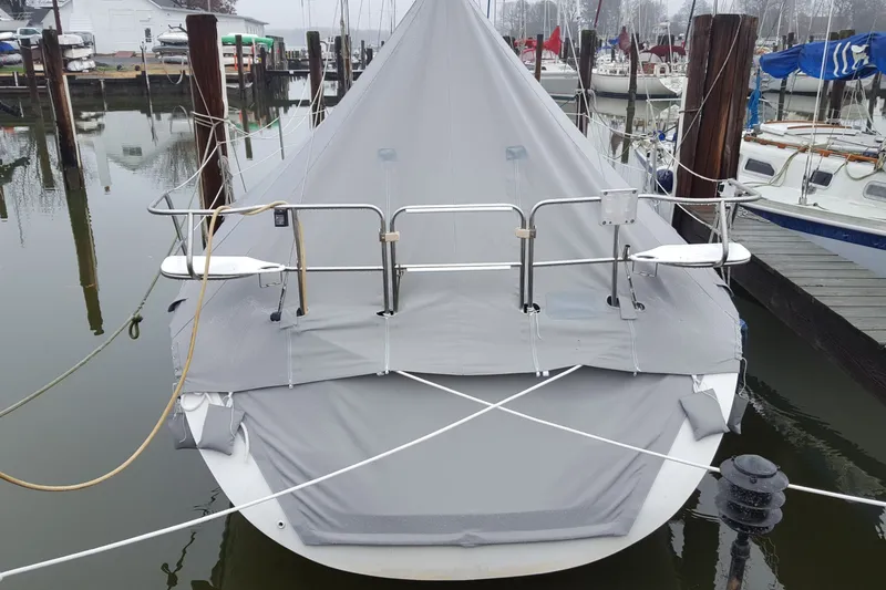 Slide: The Image of 1998 Catalina 320 sailboat with protective cover docked at marina. - 7