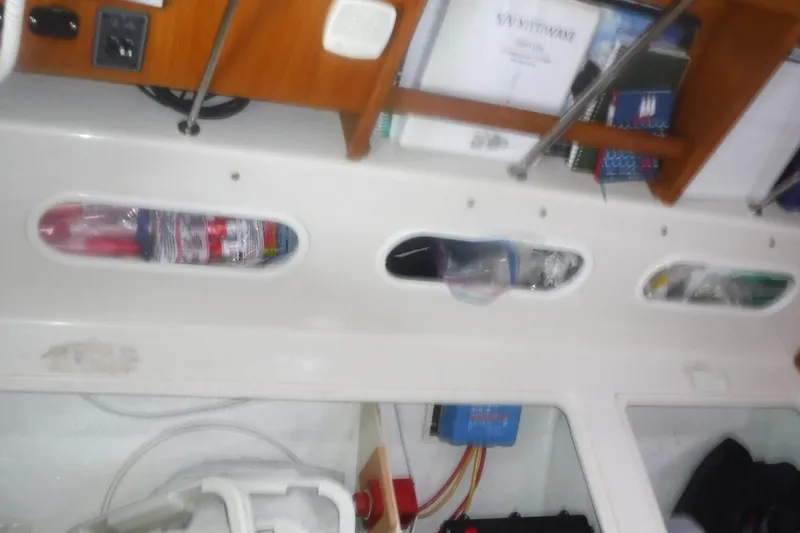 Slide: The Image of Interior view of a 1998 Catalina 320 sailboat with organized storage compartments. - 73