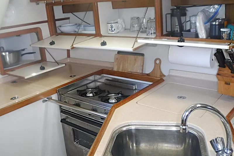 Slide: The Image of Compact galley kitchen in a 1998 Catalina 320 sailboat with stove and sink. - 43