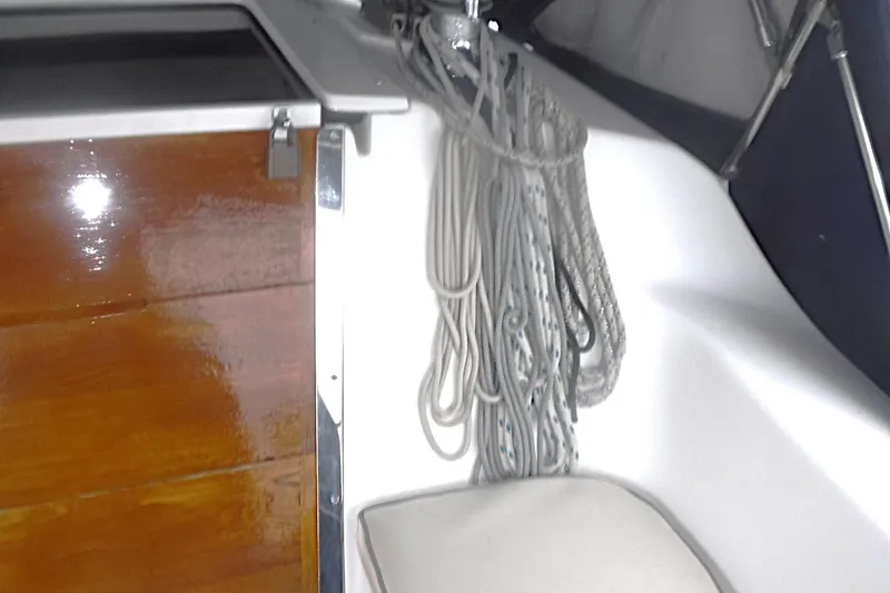Slide: The Image of Interior of a 1998 Catalina 320 sailboat showing ropes and polished wood paneling. - 31