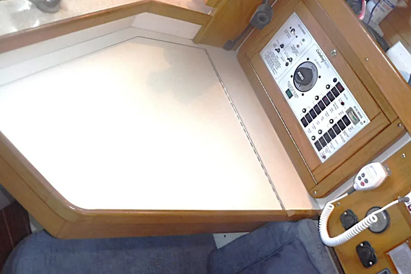 Slide: The Image of Navigation station of a 1998 Catalina 320 sailboat with control panel and radio. - 43