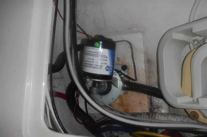 Slide: The Image of Electrical bilge pump in 1998 Catalina 320 sailboat, surrounded by wiring and hoses. - 75