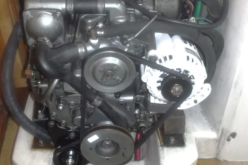 Slide: The Image of Engine of a 1998 Catalina 320 sailboat, featuring belts and pulleys. - 71