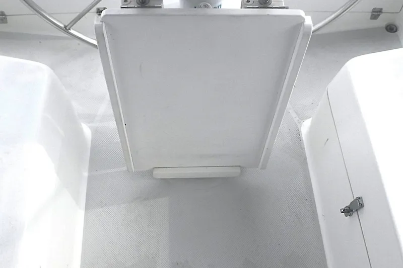 Slide: The Image of Cockpit area of a 1998 Catalina 320 sailboat, featuring a central folding table. - 24