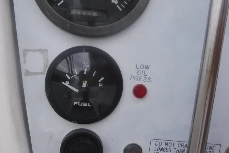 Slide: The Image of Fuel gauge and low oil pressure indicator on a 1998 Catalina 320 boat dashboard. - 21