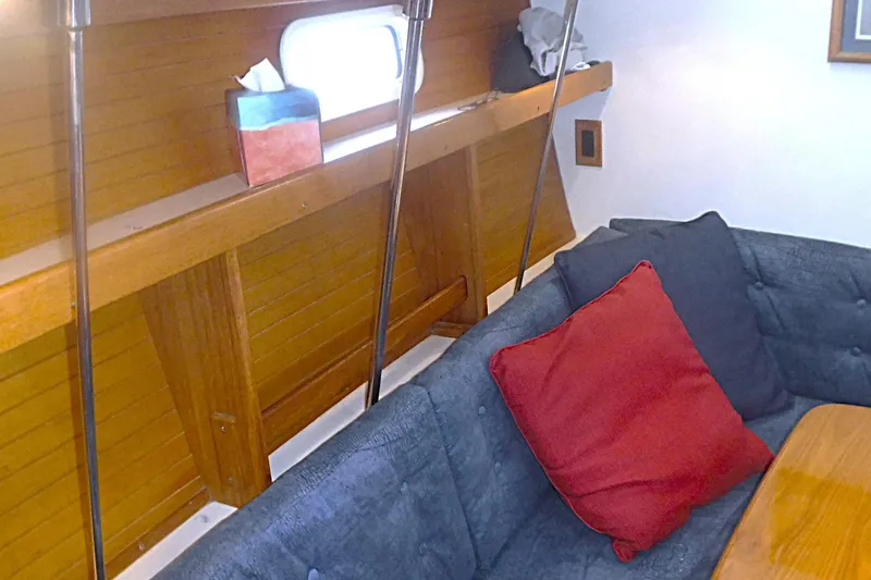Slide: The Image of Interior of a 1998 Catalina 320 sailboat with cozy seating and wooden accents. - 51