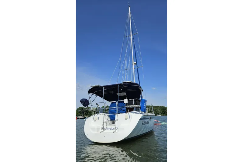 Slide: The Image of Sailboat Catalina 320, 1998 model, anchored on a sunny day with clear blue skies. - 1