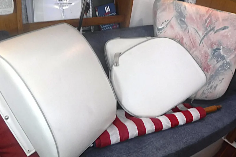 Slide: The Image of Cushions and flag inside a 1998 Catalina 320 sailboat cabin. - 57