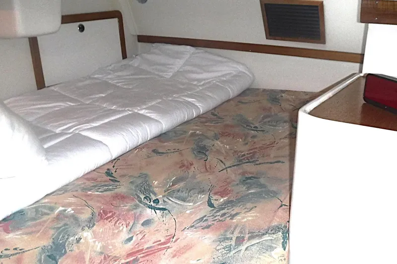 Slide: The Image of Cozy cabin interior of a 1998 Catalina 320 sailboat with a comfortable bed. - 59