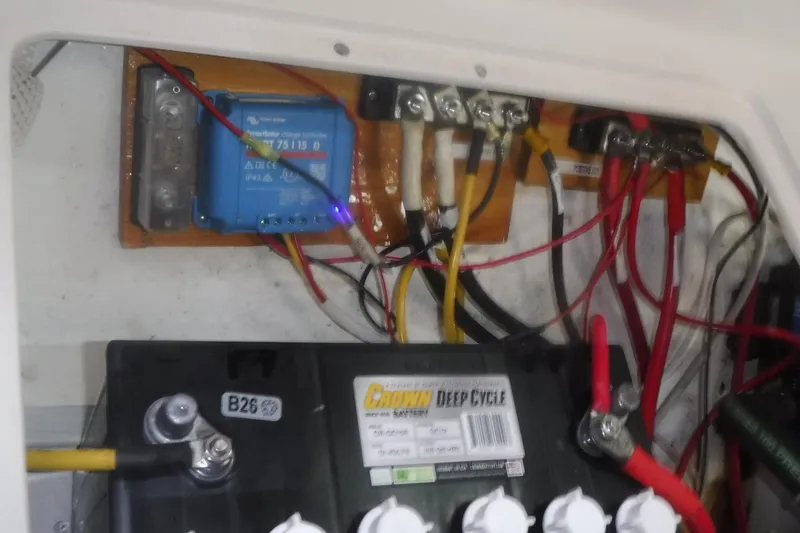 Slide: The Image of Electrical setup in a 1998 Catalina 320 sailboat, featuring a deep cycle battery and wiring. - 80