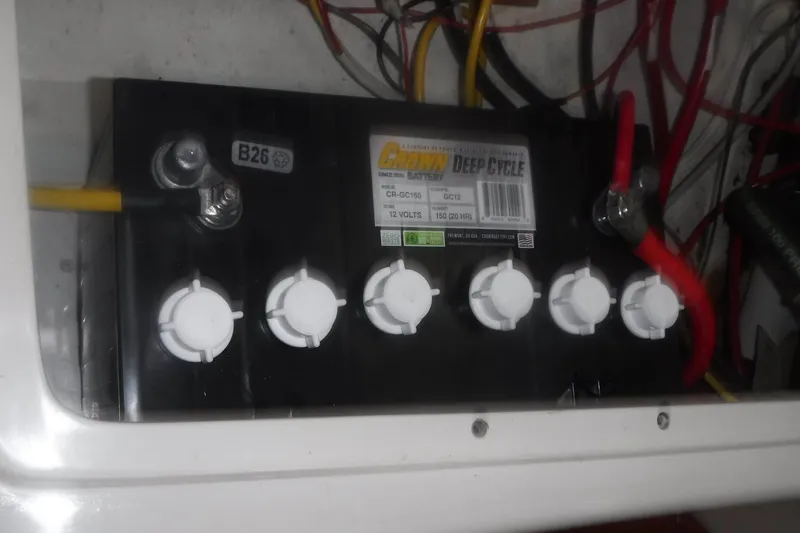 Slide: The Image of Deep cycle battery in a 1998 Catalina 320 sailboat, connected with red and yellow cables. - 79