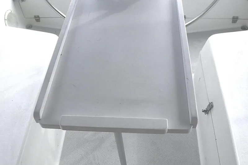 Slide: The Image of Cockpit table on a 1998 Catalina 320 sailboat, featuring a sleek white design. - 25
