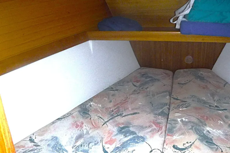 Slide: The Image of Interior cabin of a 1998 Catalina 320 sailboat with patterned cushions. - 55