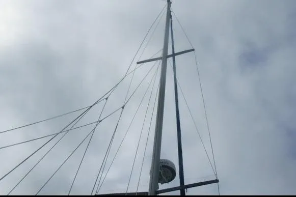 Slide: The Image of Mast of a 1998 Catalina 320 sailboat against a cloudy sky. - 5
