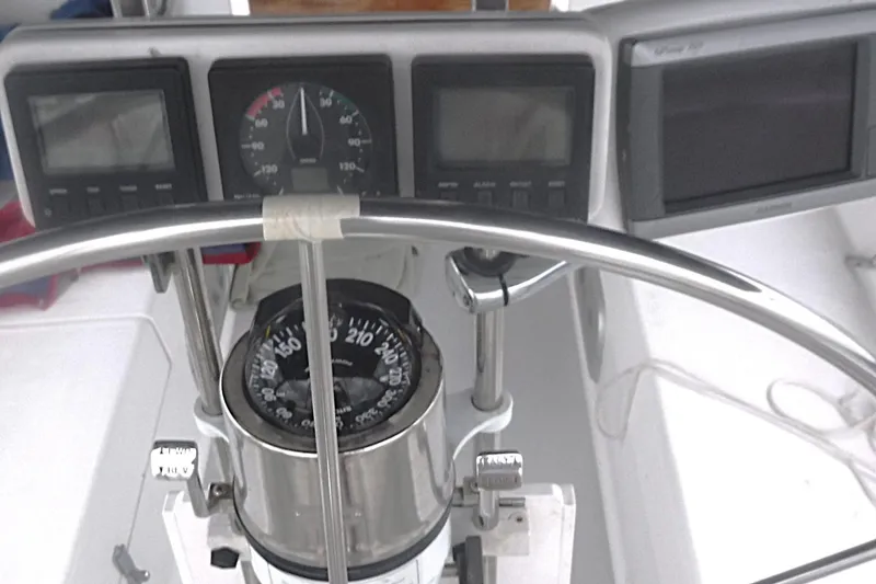 Slide: The Image of Cockpit of a 1998 Catalina 320 sailboat with compass and navigation instruments. - 19