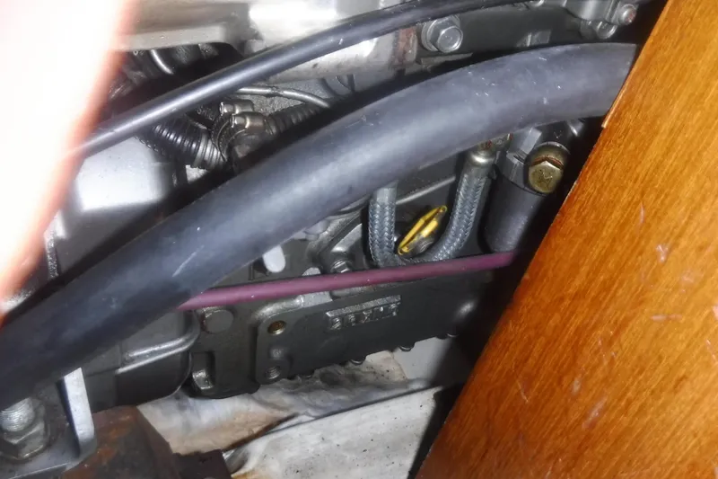 Slide: The Image of Engine compartment of a 1998 Catalina 320 sailboat, showing hoses and components. - 69