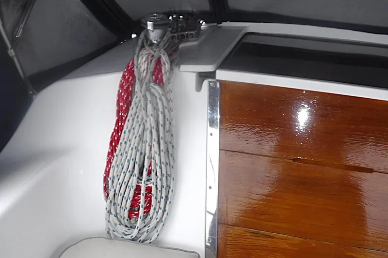Slide: The Image of Coiled ropes on a 1998 Catalina 320 sailboat with polished wooden paneling. - 30