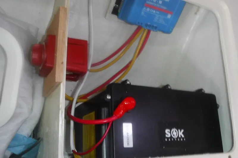 Slide: The Image of Battery compartment of a 1998 Catalina 320 sailboat with SOK battery and wiring. - 74