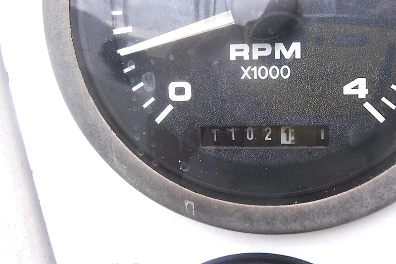 Slide: The Image of Close-up of a Catalina 320 tachometer showing 1021 RPM, model year 1998. - 22
