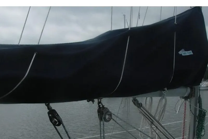 Slide: The Image of Sail cover on a 1998 Catalina 320 sailboat, docked on a cloudy day. - 8