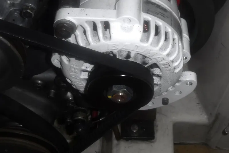 Slide: The Image of Alternator of a 1998 Catalina 320 engine with visible belt and mounting. - 72