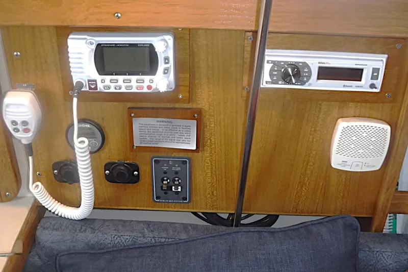 Slide: The Image of Control panel of a 1998 Catalina 320 sailboat with radio and speaker systems. - 44