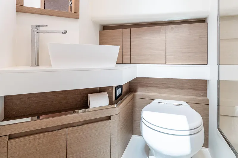 Slide: The Image of Modern bathroom interior on 2024 Pardo Yachts 43, featuring sleek fixtures and wood cabinetry. - 41