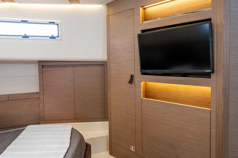 Slide: The Image of Luxurious interior of 2024 Pardo Yachts 43 with modern wood paneling and mounted TV. - 39