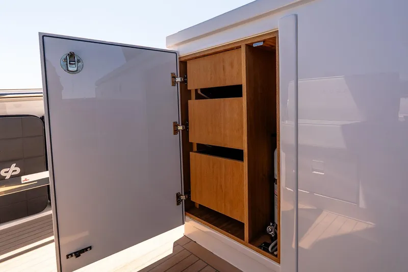 Slide: The Image of Open storage compartment on 2024 Pardo Yachts 43, featuring wooden shelves and sleek design. - 25
