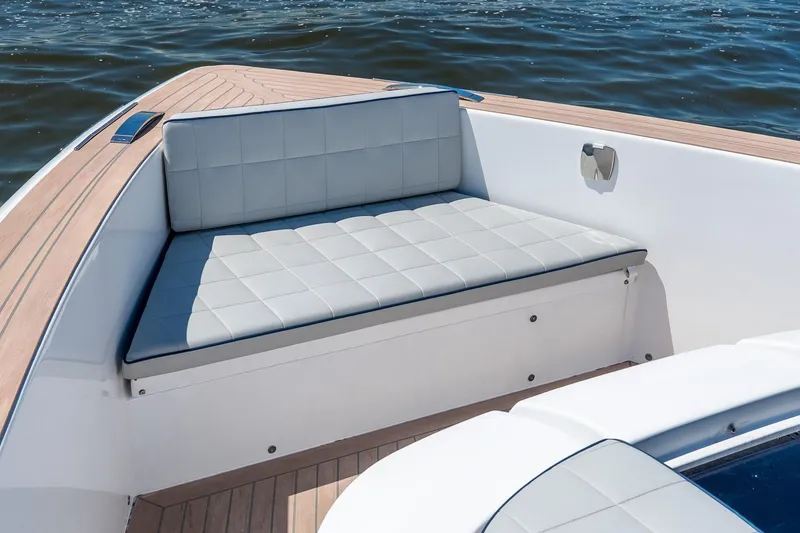 Slide: The Image of 2024 Pardo Yachts 43, elegant seating area with cushioned bench, on calm water. - 54