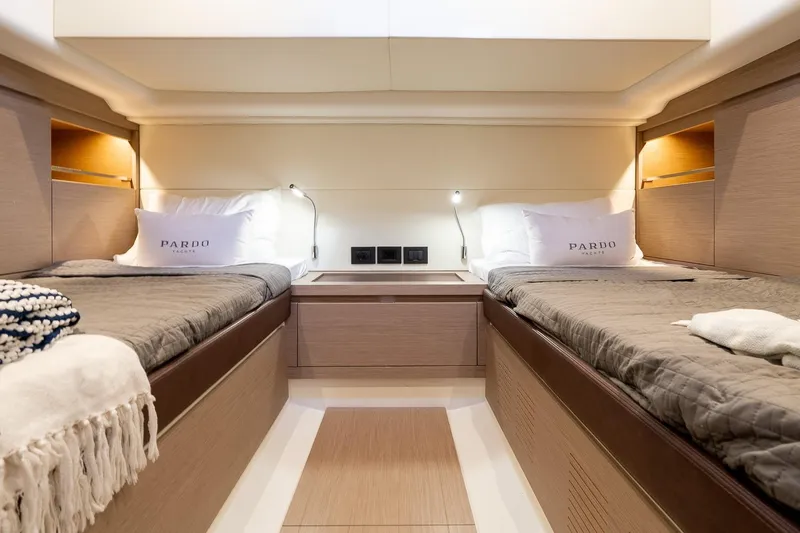 Slide: The Image of Luxurious twin cabin interior of 2024 Pardo Yachts 43, featuring elegant bedding and ambient lighting. - 43