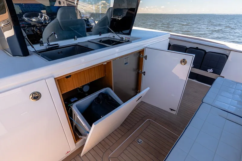Slide: The Image of 2024 Pardo Yachts 43 interior with open storage, sink, and seating on deck. - 24