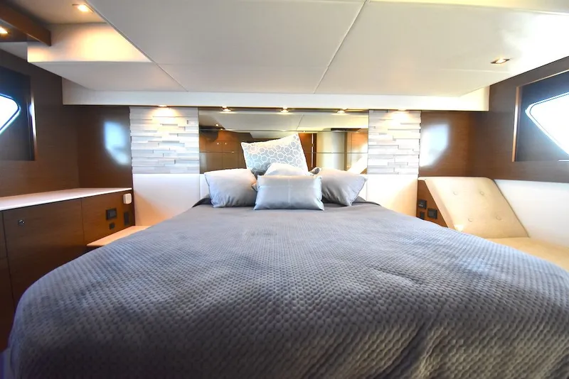 Slide: The Image of Luxurious bedroom with a large bed, modern accents, and side windows on a yacht. - 37