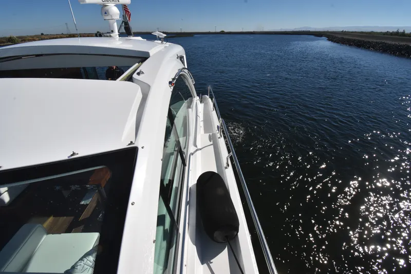 Slide: The Image of A 2019 Cruisers Yachts 50 Cantius navigating calm waters under sunny skies. - 45