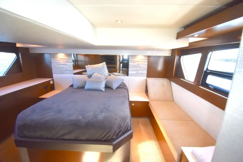 Slide: The Image of Luxurious cabin with a double bed, modern wood accents, and large windows. - 32