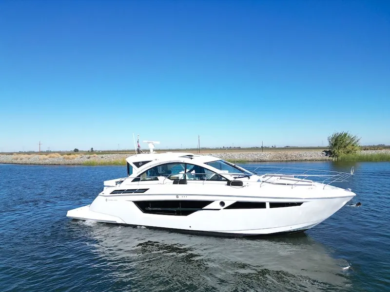 Slide: The Image of A luxurious white motor yacht cruising on calm waters under a clear blue sky. - 2