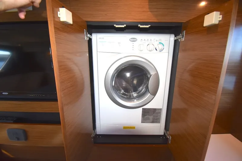 Slide: The Image of Washing machine in a wooden cabin on a 2019 Cruisers Yachts 50 Cantius. - 36